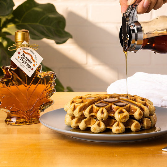 Belgian waffles cooked to perfection with a generous pour of Carman Brook Farm maple syrup.
