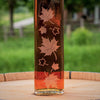 A closer look at the etched maple leaves with amber maple syrup.
