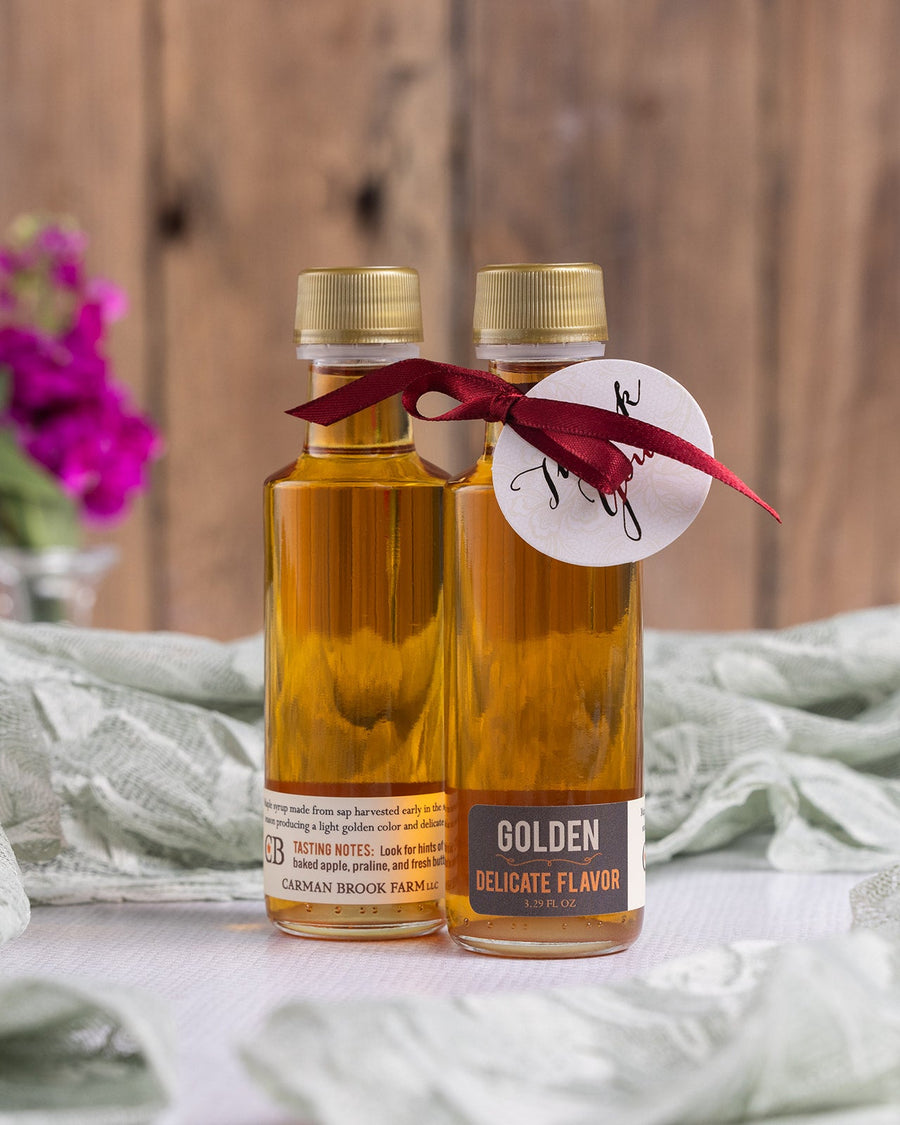 A pair of Golden Delicate Flavor maple syrup party favors.