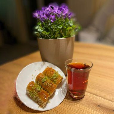 Baklava plated with a cup of tea.
