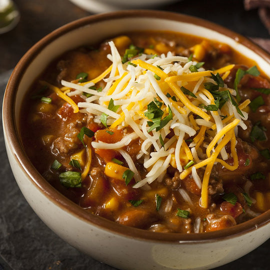 A bowl of my sweet 'n savory chili made with maple syrup and topped with cheese and cilantro.