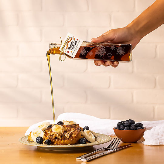 A healthy sugar alternative, maple syrup from Carman Brook Farm being poured over fruit and french toast.
