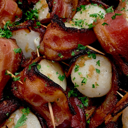Scallops wrapped in bacon with a maple glaze, get the recipe.