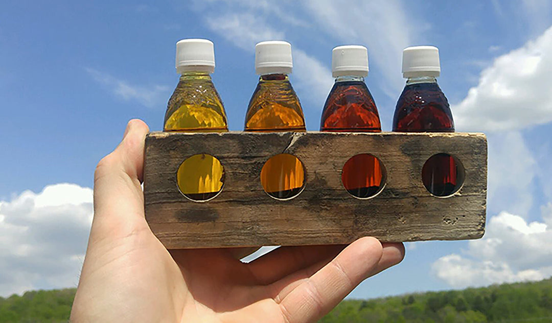 Bottles of Golden, Amber, Dark, and Very Dark Grade A Vermont maple syrup.