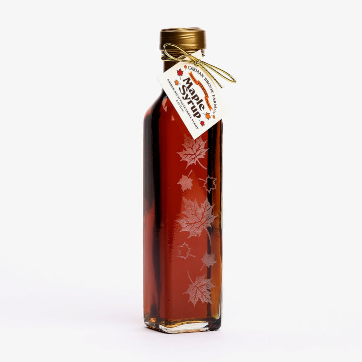Vermont maple syrup Autumn Leaf glass bottle filled with Dark Robust Taste syrup.