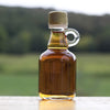 A rustic wedding favor in a farm setting, these bottles of maple syrup with a handle work perfectly.