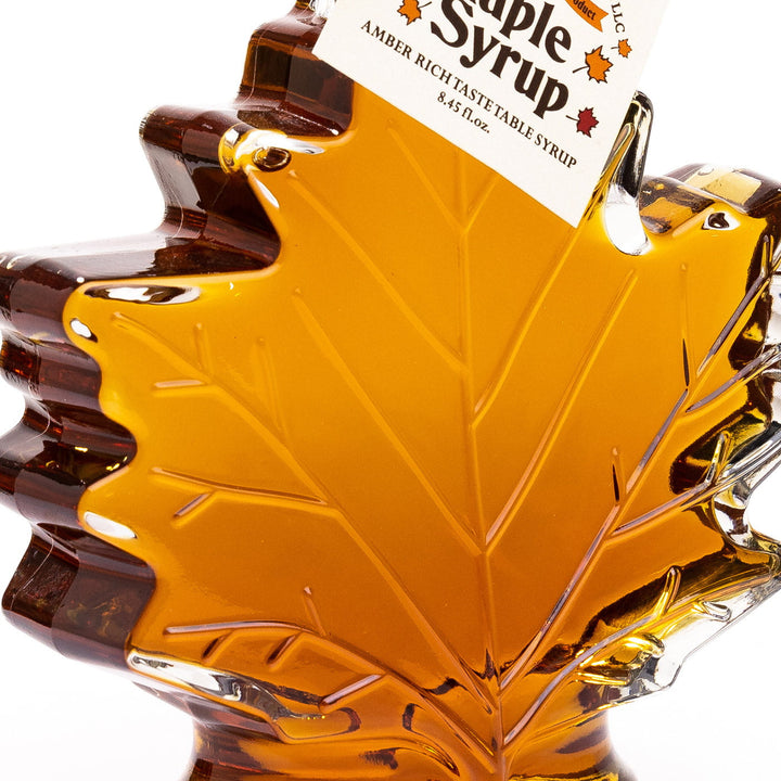 Close-up of raised glass leaf design on Vermont maple syrup bottle.