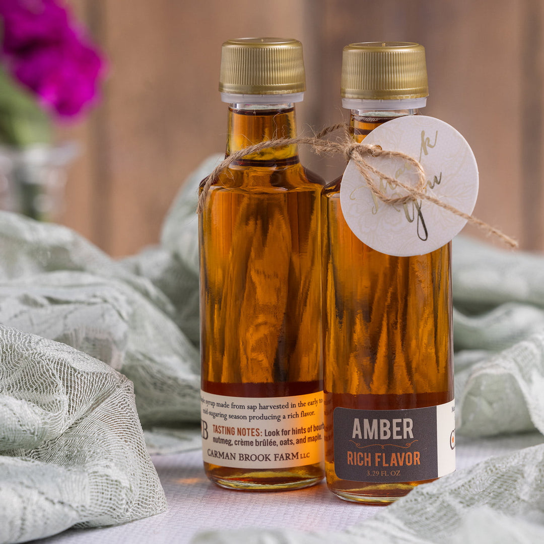 Amber rich Vermont maple syrup wedding favor bottle styled for wedding table setting.