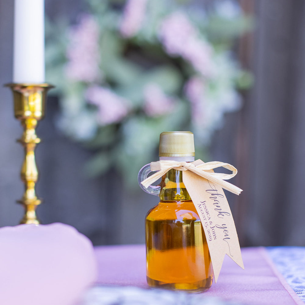 Maple syrup Vermont wedding favor displayed at a rustic wedding place setting.