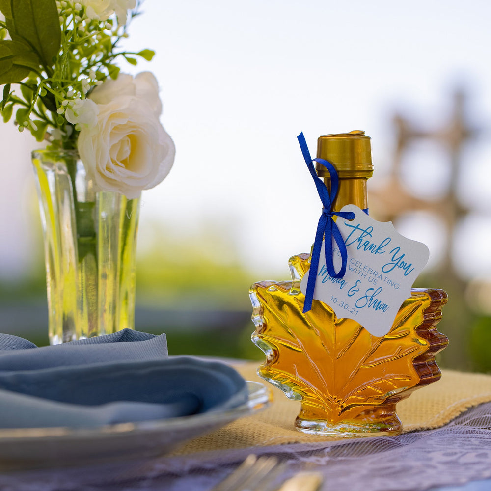 maple syrup wedding favor displayed on rustic wedding table.