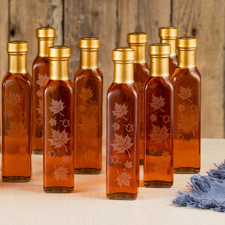 Vermont maple syrup wedding favors in 8.45 oz autumn leaf bottles grouped together for gifting.