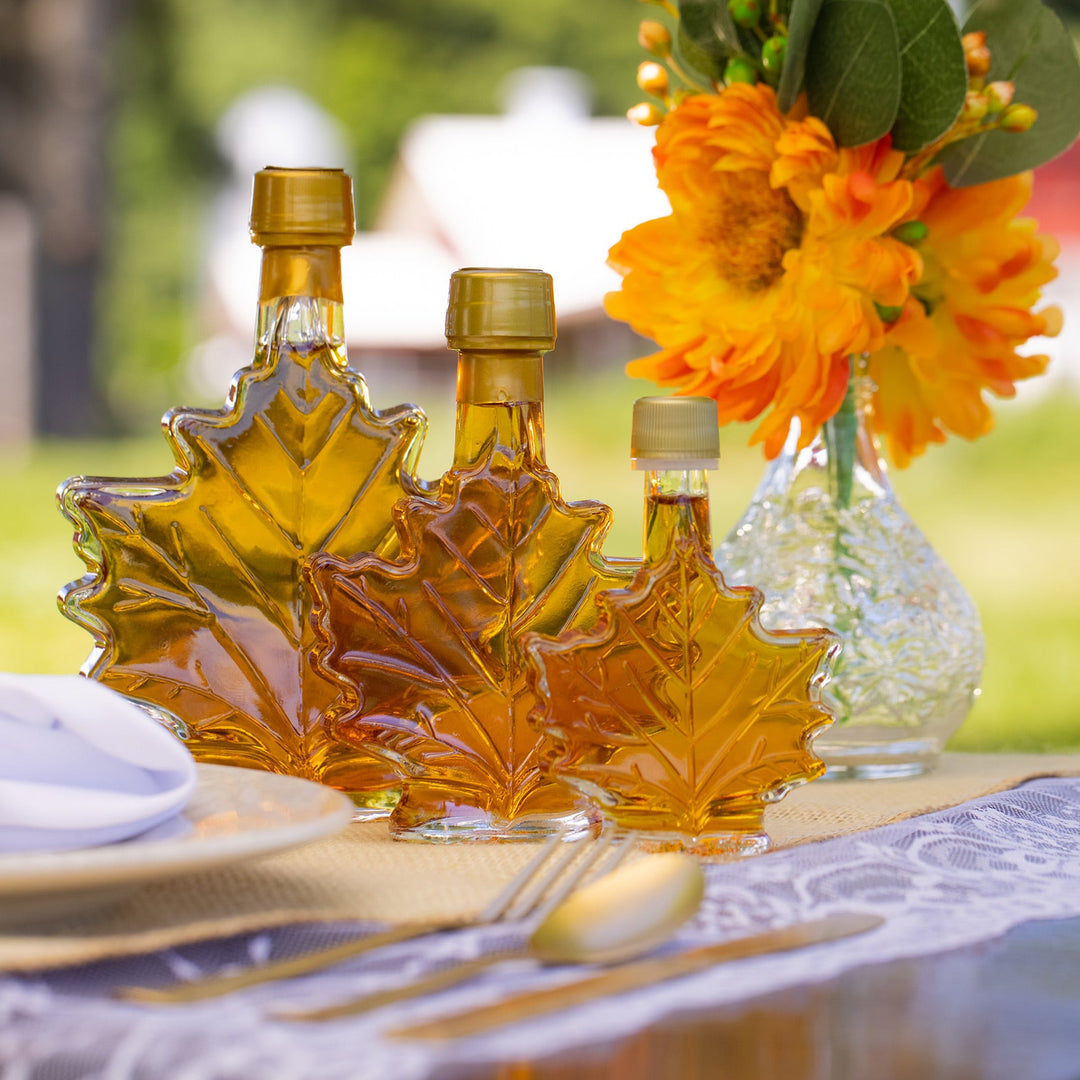 Vermont maple syrup wedding favors showing 1.7 oz, 3.29 oz, and 8.45 oz maple leaf bottles