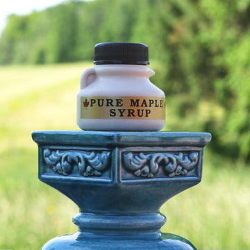 Mini nip bottle filled with Vermont maple syrup for party favors.